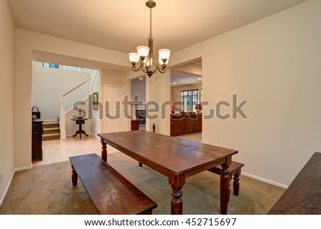 Open floor plan. View of dining room with Carved wooden table, living room and hallway with staircase