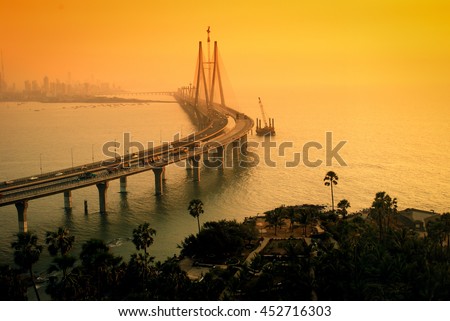 The Bandra-Worli Sea Link, also called Rajiv Gandhi Sea Link at dusk. It is a cable-stayed vehicular bridge that links Bandra in the northern suburb of Mumbai with Worli in South Mumbai.  Royalty-Free Stock Photo #452716303