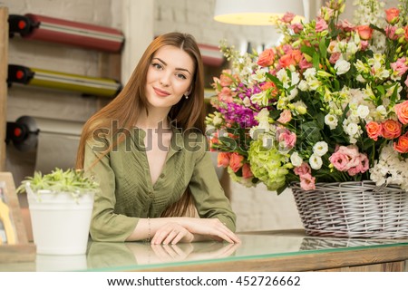 Working with flowers. Portrait of a gorgeous young florist leaning on a counter at her own flower shop smiling cheerfully 