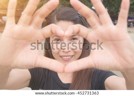 Hands woman make a heart