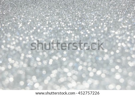 The Abstract blur silver bokeh lighting from glitter texture. Luxury design background.