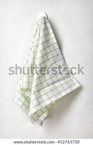 White green squared towel hanging on white bathroom wall background