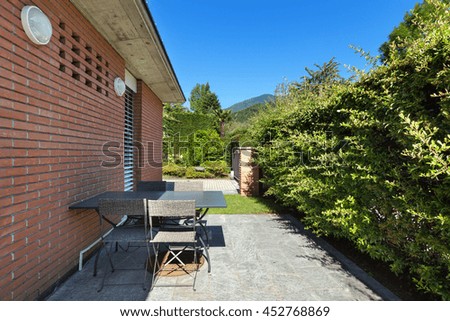 Patio of a modern brick house, outdoors