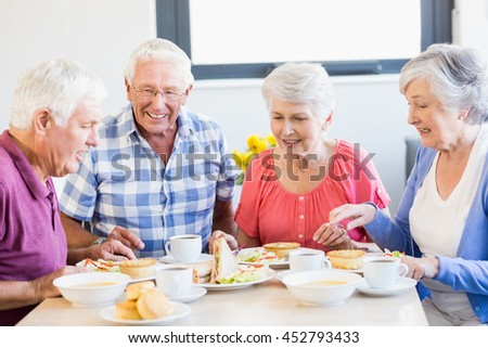 Seniors having lunch together in a retirement home