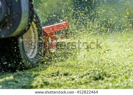 lawnmower at work Royalty-Free Stock Photo #452822464