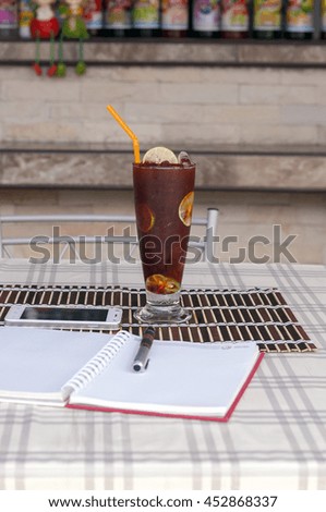 lemon tea in this glass . The panel is placed on bamboo Along with a notebook and a mobile phone