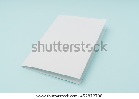 Bifold white template paper on blue background Royalty-Free Stock Photo #452872708