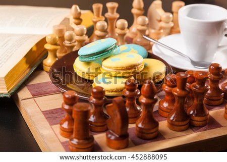 cake on a chessboard and glass of coffe