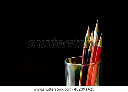 Colors pencil  in glass  with back  background