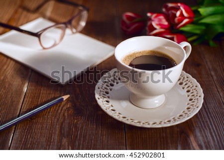 Coffee cup with note book and glases. Retro style pictures