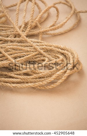 pile of old ropes made of braided hemp on brown floor