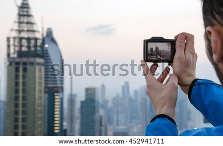 Man taking a photo with his camera in Dubai, OAE