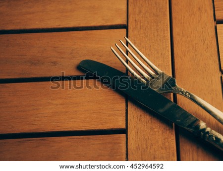 knife and fork and  wooden background
