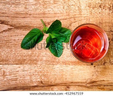 Cold alcohol drink on wooden background