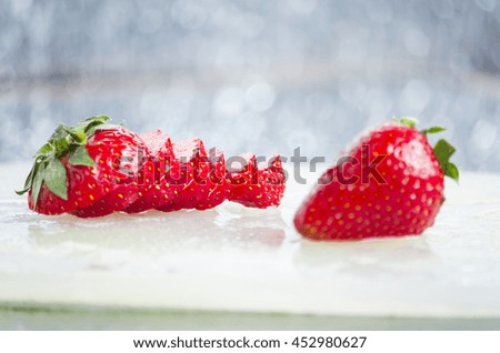 Sliced strawberry on white kitchen board. 