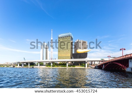 modern office buildings and elevated bridge near tokyo tower in downtown of tokyo in blue sky