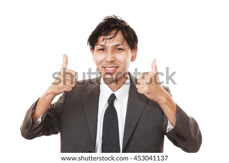 Asian business man showing thumbs up sign 