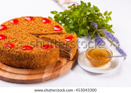 Honey cake with green grass on white table