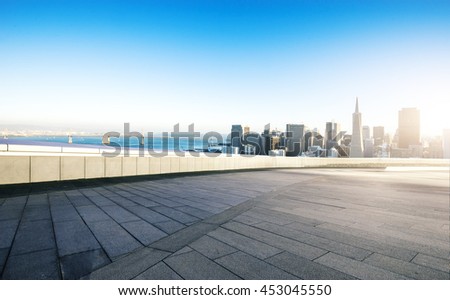 cityscape and skyline of san francisco at sunrise on view from empty street