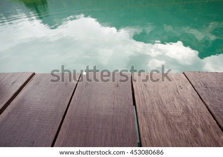 wood plank platform with green lake background. concept for blur background, relax, vacation, morning, trip, travel