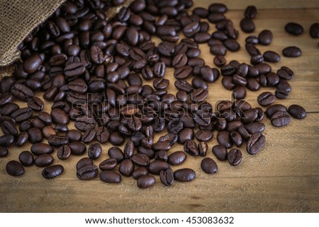 Coffee beans on wood background , Roasted coffee beans placed on a wooden floor.