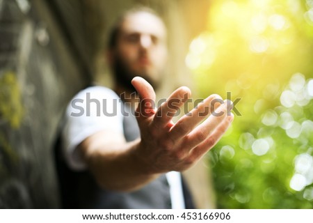 Giving a helping hand, asking or offering help close-up shot of a Caucasian man in a business suit. Royalty-Free Stock Photo #453166906