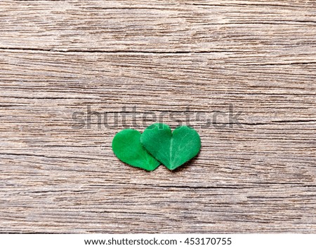 Clover leaf Similar heart taken split and stacked up at the middle of the wooden floor.