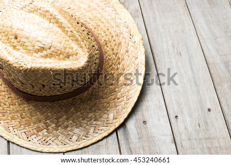 Straw hat with black strip on a table

