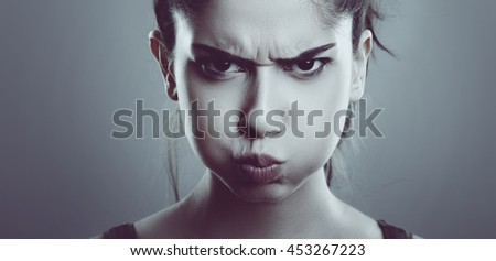 Angry stressed young woman face. Close up of Frustrated Female. Royalty-Free Stock Photo #453267223