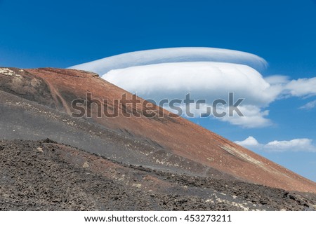 Slopes of Mount Etna with spectacular cloudy sky at Sicily, Italy