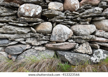 Very old stone wall detail. Unusual construction using both round and flat rocks without mortar. Location: Faro Island near Gotland, Sweden