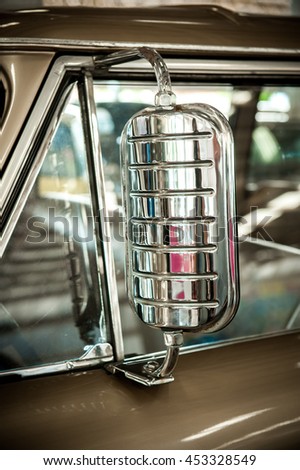 Chrome rear view mirror vintage car. Vintage style picture - selective focus.