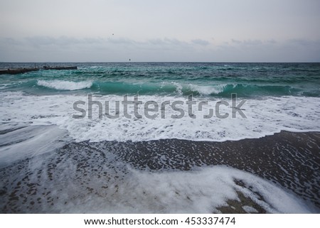 Dark clouds and crashing ocean waves during storm