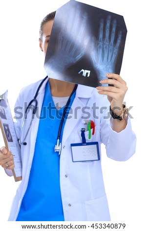 Young female doctor looking at the x-ray picture isolated on white background