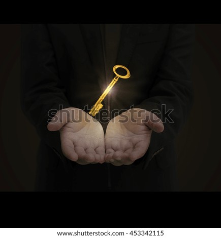 Businessman hold a gold shining key, business concept