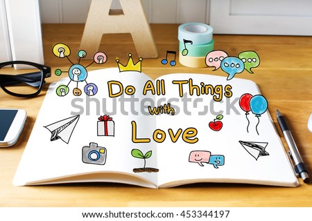 Do All Things with Love concept with notebook on wooden desk 