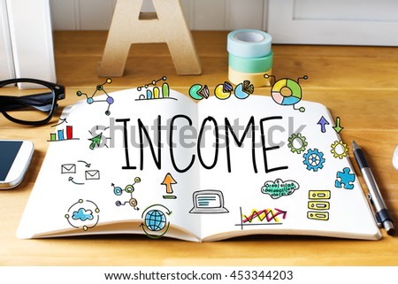 Income concept with notebook on wooden desk 
