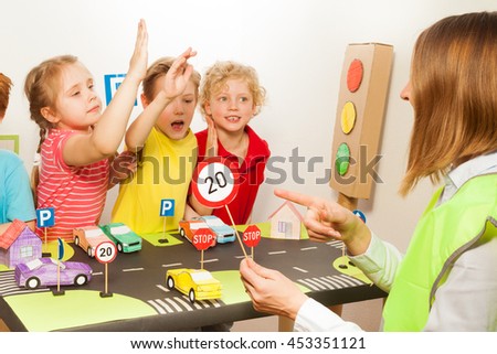 Smart happy kids studying traffic regulation rules