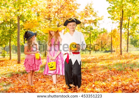 Three children in Halloween costumes together