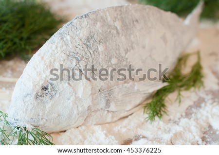 raw fish dorado flour close-up on a table