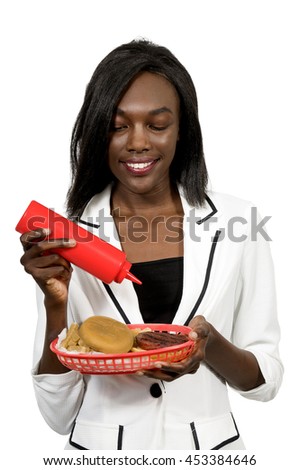 Woman carrying a tray of hamburgers and fries