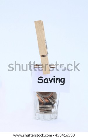 Many coins in the glass with 'saving' tag