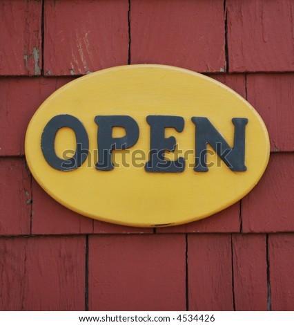 Yellow "open" sign on a wall.