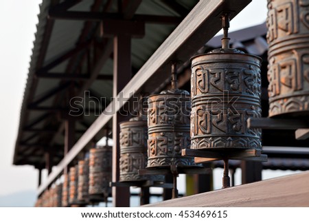 Religious prayer wheel for meditation in a Buddhist temple in Buryatia, Russia Ulan-Ude. Royalty-Free Stock Photo #453469615