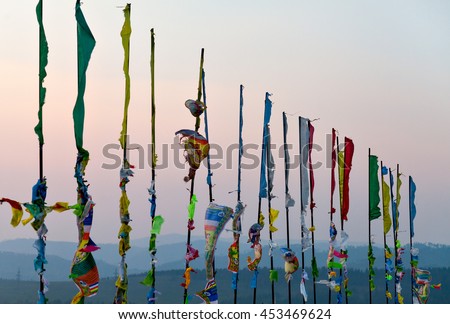 Prayer flags and Hadak at sunset in the Republic of Buryatia. Datsan Rinpoche Bagsha on Bald Mountain in Ulan-Ude, Russia. Royalty-Free Stock Photo #453469624