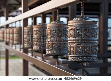 Religious prayer wheel for meditation in a Buddhist temple in Buryatia, Russia Ulan-Ude. Royalty-Free Stock Photo #453469639