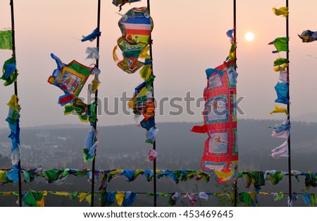 Prayer flags and Hadak at sunset in the Republic of Buryatia. Datsan Rinpoche Bagsha on Bald Mountain in Ulan-Ude, Russia. Royalty-Free Stock Photo #453469645