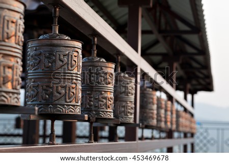 Religious prayer wheel for meditation in a Buddhist temple in Buryatia, Russia Ulan-Ude. Royalty-Free Stock Photo #453469678