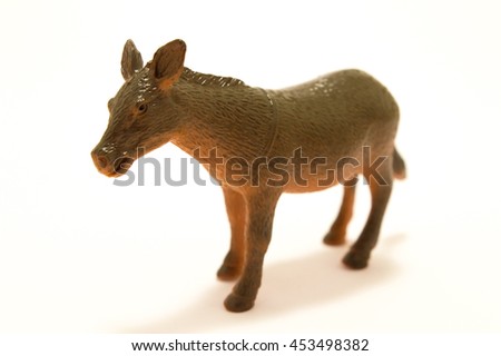 Toy donkey made of plastic on a white background