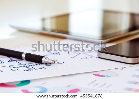 Mobile Business Background with color printed professional Chart and hand written Scheme on piece of Paper and digital Gadgets screens with Office Interior Reflections